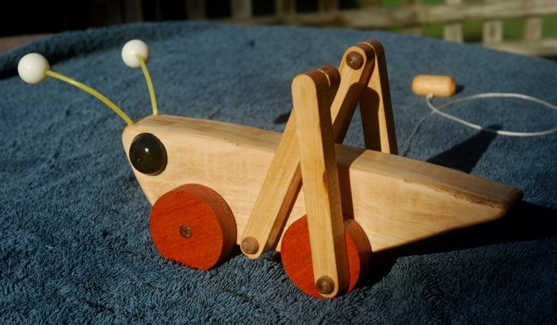 wooden grasshopper pull toy
